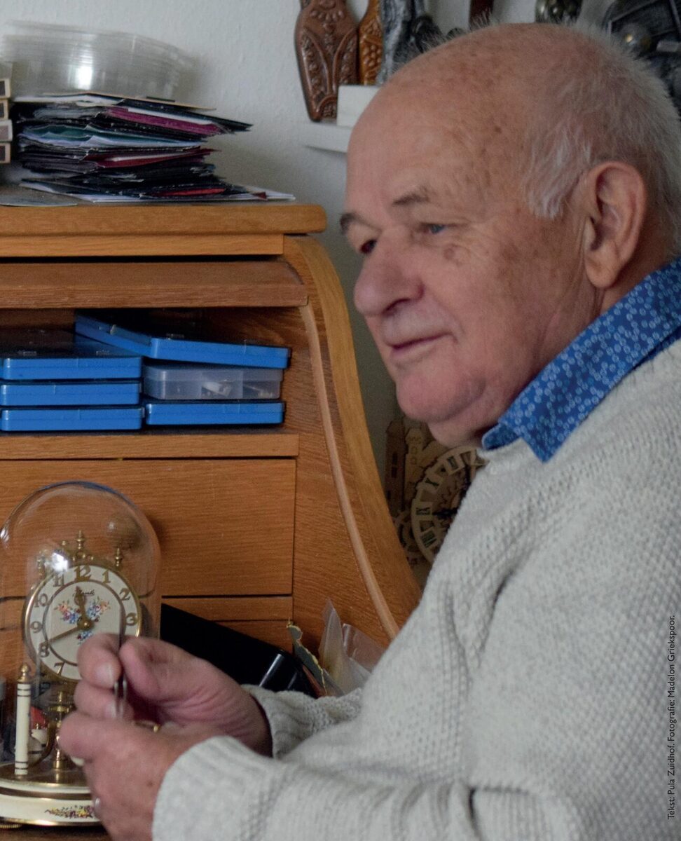 Vok van Balen aan zijn werkhoek vol horlogemakersgereedschap